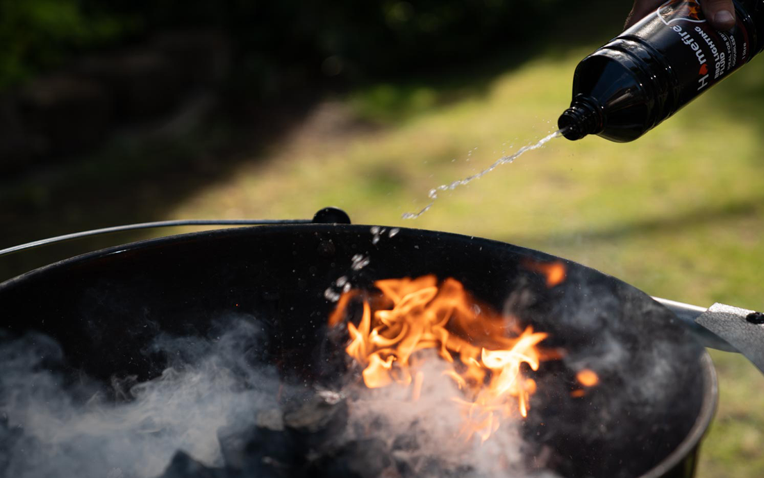 Barbecue lighting fluid being poured onto the barbecue